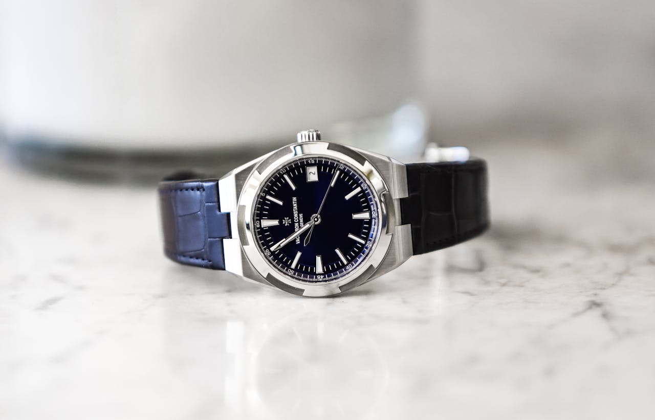 Sophisticated luxury wristwatch with leather strap displayed on a marble surface, showcasing elegance and precision.